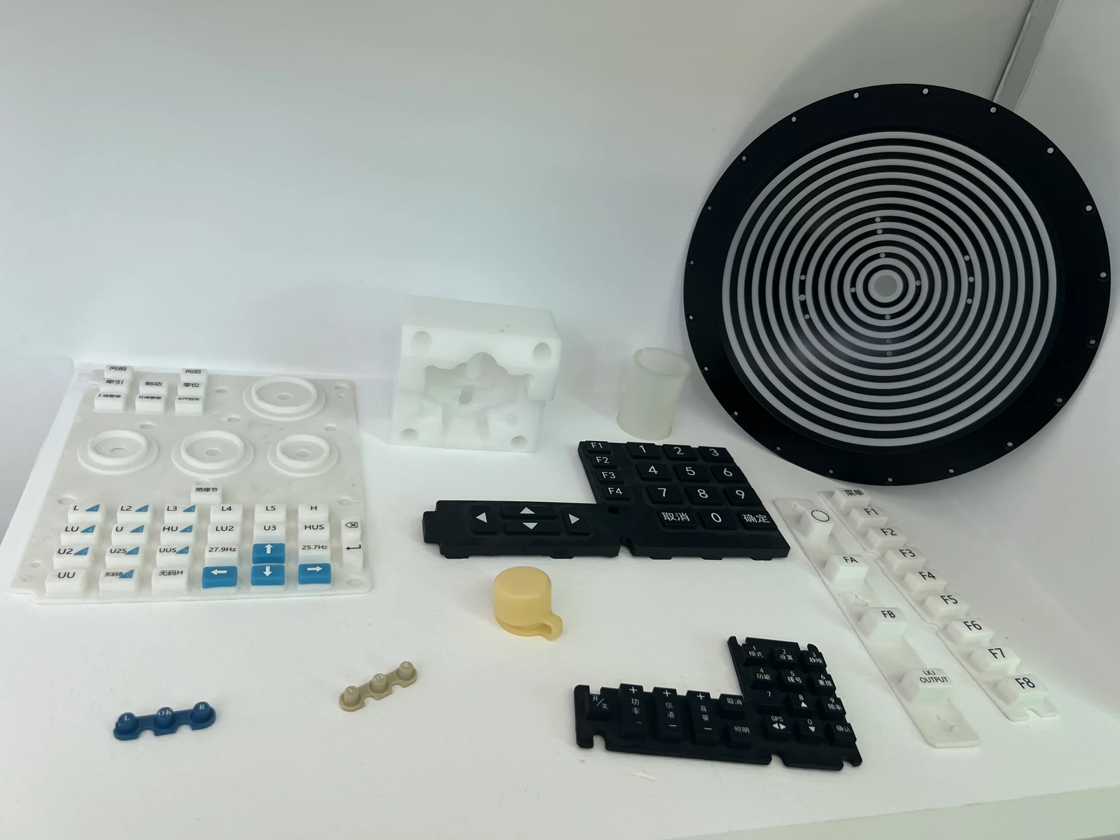 Screen-printed rubber keypads and shaped samples · company photograph